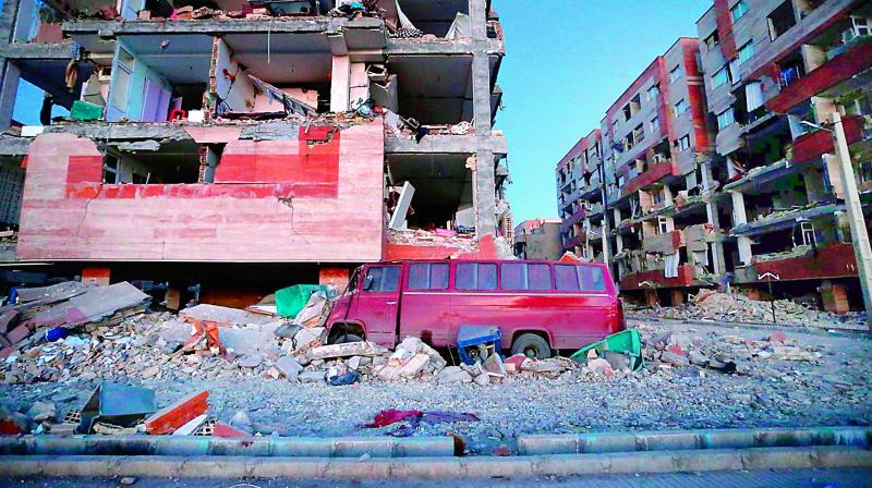 A damaged van and buildings following a 7.3-magnitude earthquake at Sarpol-e Zahab in Irans Kermanshah province on Monday. (Photo: AFP)