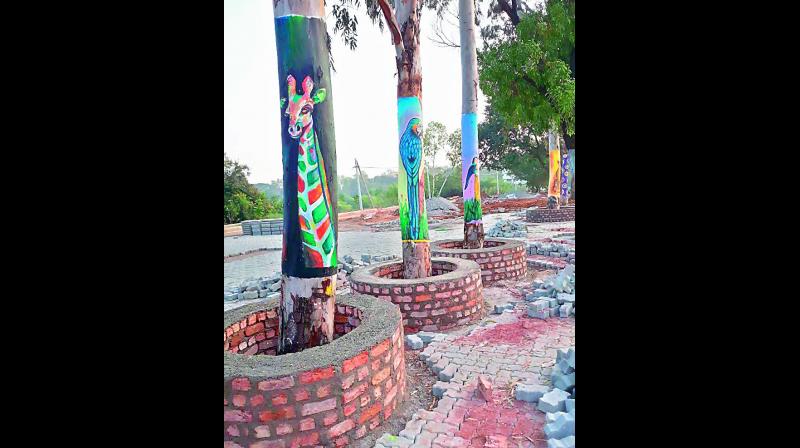 Trees being painted at NAC Hitec City for Global Entrepreneurship Summit-2017. (Photo: DC)