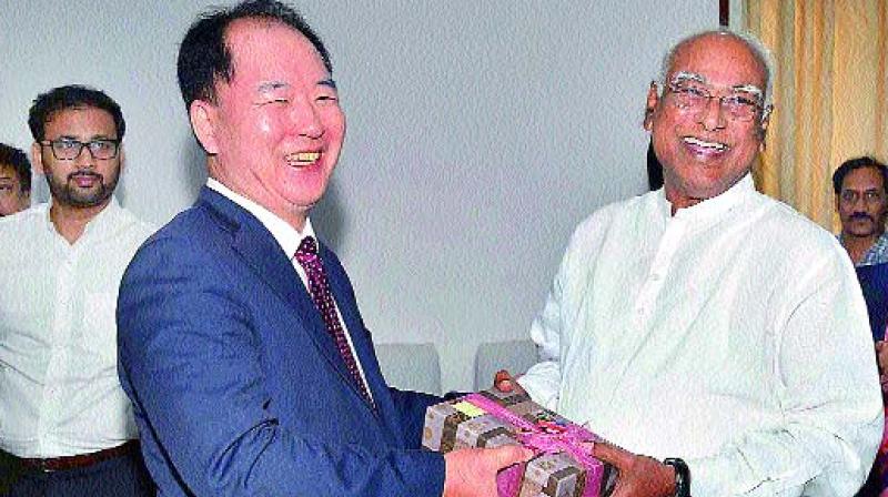 Chairman of Vignan Group of institutions Dr L. Rathaiah felicitates Myung Tae Kim, Consulate General of Republic of Korea for South India during his visit to  Valdamudi village in Guntur district on Thursday.