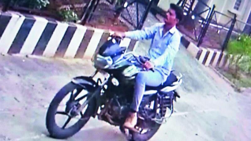 CCTV footage of the chain snatcher travelling on a bike.