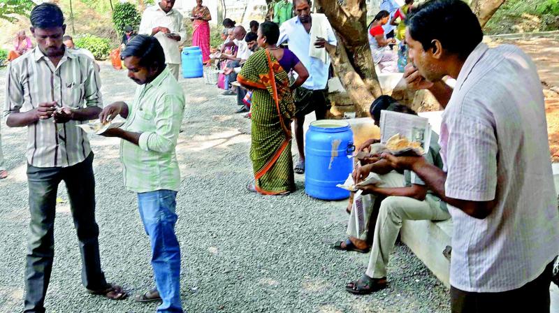 Patients and their relatives have free chapatis at the government hospital premises in Vijayawada on Friday.