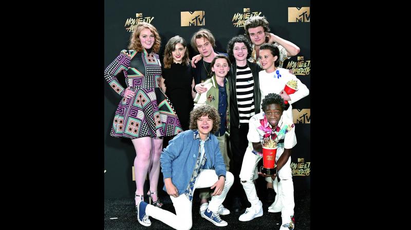 The Stranger Things kids looked dashing on the red carpet at the American Music Awards in Los Angeles on Sunday.
