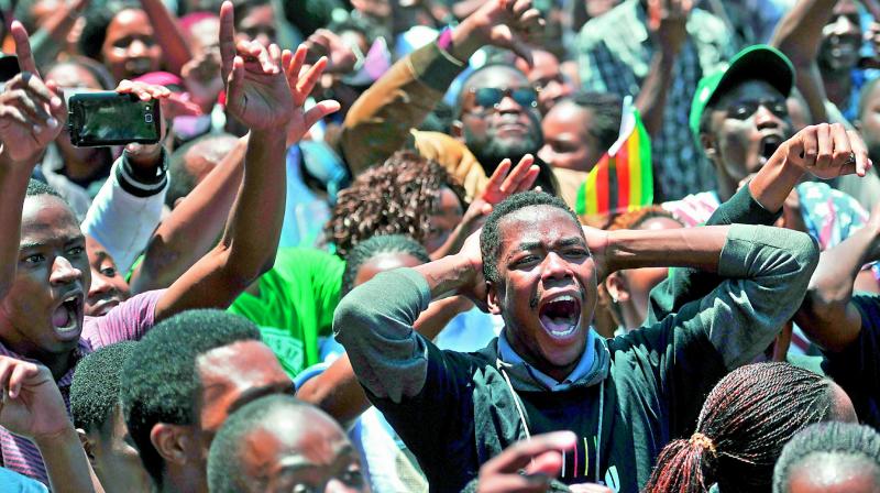 University of Zimbabwes students take part in a demonstration on Monday in Harare to demand the withdrawal of Grace Mugabes doctorate and refused to sit their exams as pressure builds on Zimbabwes President Robert Mugabe to resign.