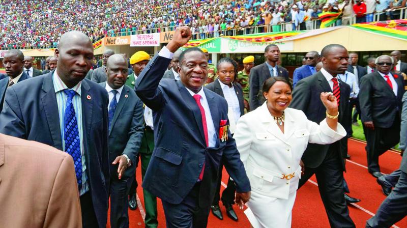 Emmerson Mnangagwa, center, and his wife Auxillia, center-right, arrive at the Presidential inauguration ceremony in Harare on Friday. (Photo: AFP)