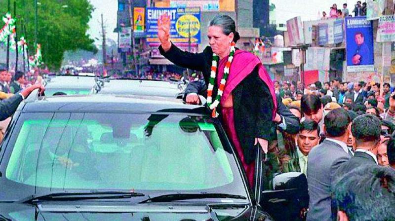 Politicians are often seen waving to their supporters from the moving car. (Sonia Gandhi)