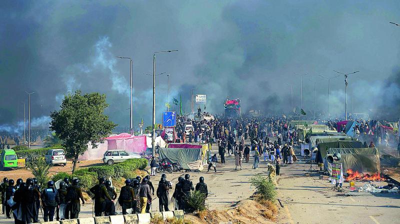 Smoke rises from a blocked flyover as protesters from the Tehreek-i-Labaik Yah Rasool Allah Pakistan religious group clash with police in Islamabad. (Photo: AFP)