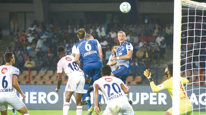 Bengaluru FCs Erik Paartalu directs a header towards goal against Delhi Dynamos on Sunday.(Photo:  SHASHIDHAR B.)