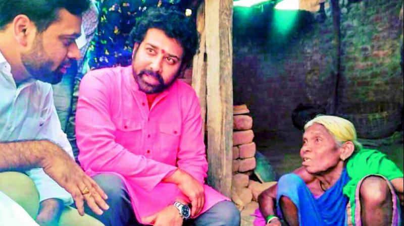 Actor Shiva Balaji interacts with an elderly tribal woman in Tiviti village on Sunday. (Photo: DC)