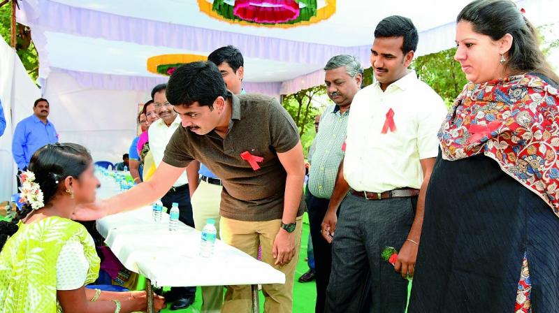 Guntur collector K. Sasidhar, Guntur Urban SP Ch. Vijaya  Rao and JC Kritika Sukla interact with children affected by AIDS during My Health - My Right programme held marking the  World AIDS Day in Guntur on Friday. (Photo: DC)