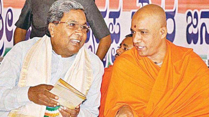 A file photo of CM Siddaramaiah with Adichunchangiri Maths Niramalanandanath Swamiji (Photo: Representational Image)