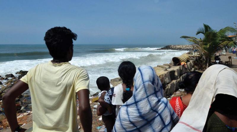 Locals wait looking at the sea for their dear ones to return. A scene from Poonthura in Thiruvananthapuram on Sunday.