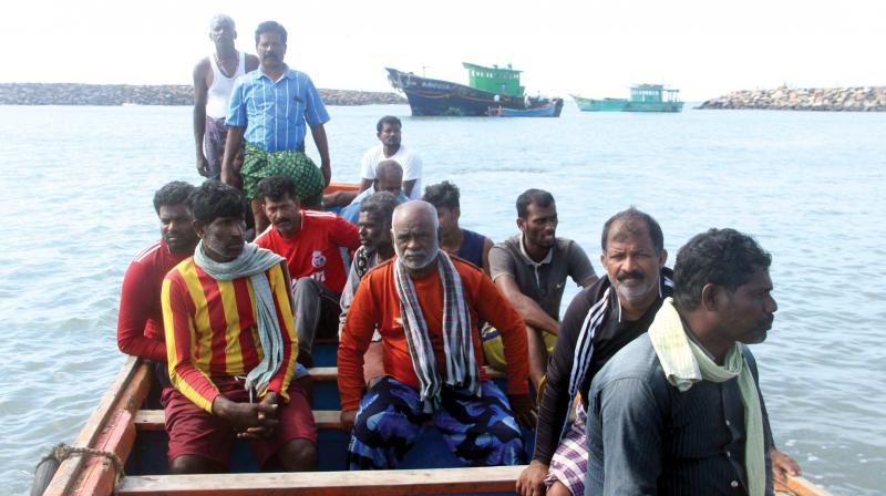 Stranded fishermen, natives of Tamil Nadu who are rescued by Coast Guard, arrive at Chellanam harbor with help of local fishermen in Kochi on Sunday. Their fishing boats are also seen. (Photo: Sunoj Ninan Mathew )