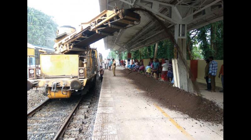 Ballast machine cleans the metals and soil on the track at Mahe station.