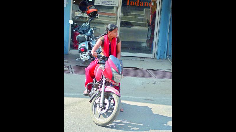 A girl drives a two-wheeler in Vijayawada. (Photo: DC)