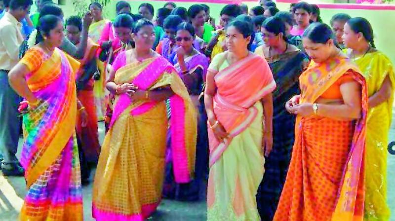 Adivasi working women stage a protest against the Lambadas for posting a video and audio insulting them on social networking site, in front of the police station in Utnoor in Adilabad district on Wednesday. 	(Photo: DC)