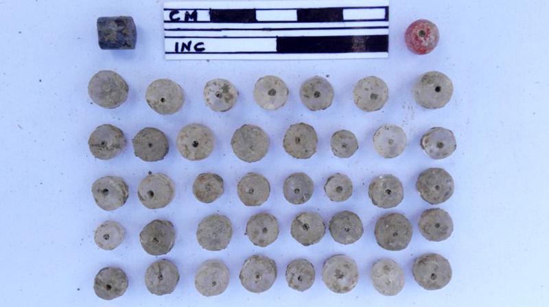 Semi-precious stone beads found during excavation of megalithic burial site at Rayannapeta