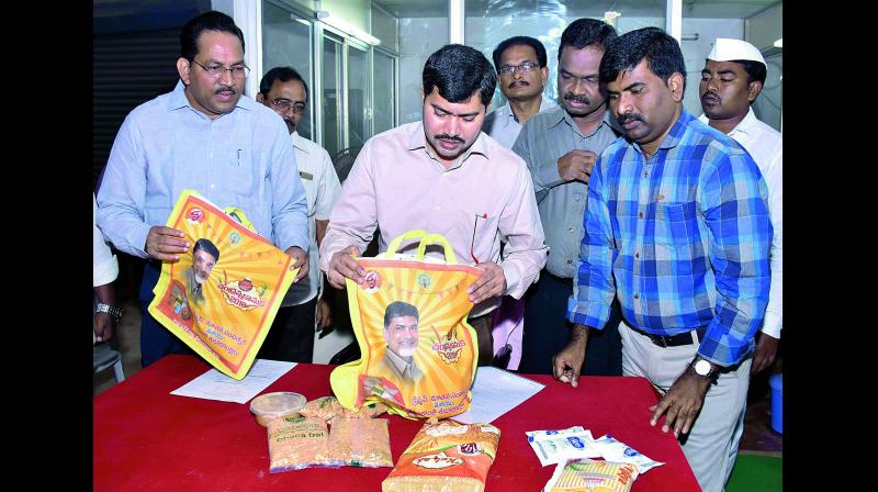 East Godavari Joint Collector A. Mallikarjuna inspects packets that would be distributed as Chandranna Kanuka for Christmas at a programme in Kakinada on Friday. (Photo: DC)