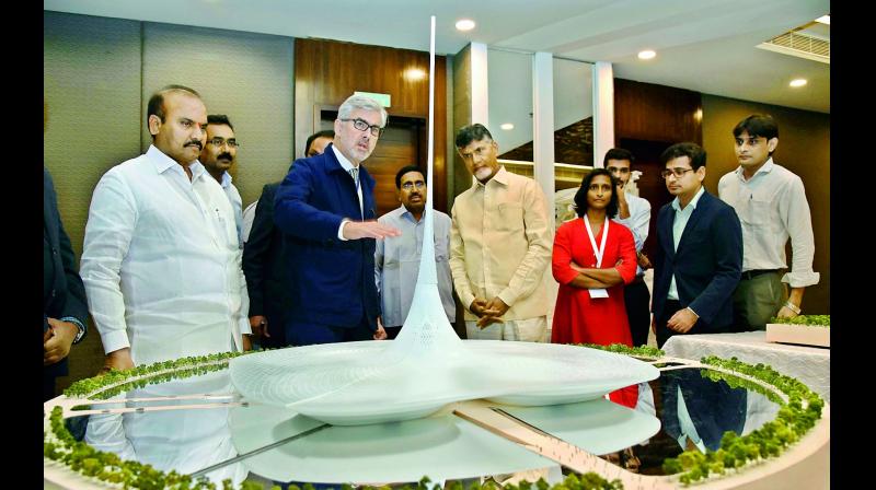 Chief Minister N. Chandrababu Naidu watches the capitals designs at the Amaravati Deep Drive workshop on the second day in Vijayawada on Friday. (Photo: DC)