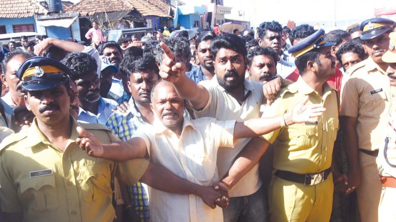 Angry protesters ask Kerala ministers Kadakampally Surendran and J. Mercy Kutty Amma to go back during their visit to Poonthura near Thiruvananthapuram. (Photo: DC)