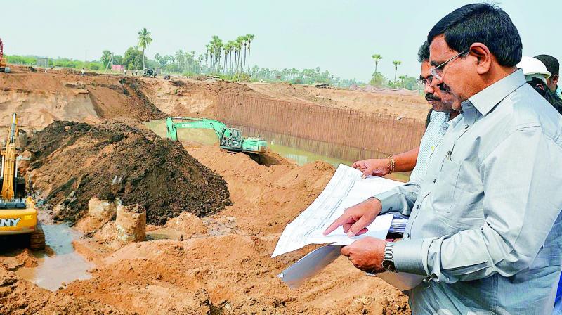 Minister P. Narayana and other officials watch the Palavagu diversion works at Abbarajupalem in Guntur district on Monday. (Photo:  DC)
