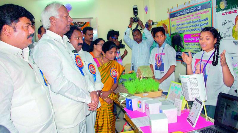 Deputy CM and education minister Kadiam Srihari listens to a student as she explains the working of her exhibit in Warangal on Thursday. (Photo: DC)