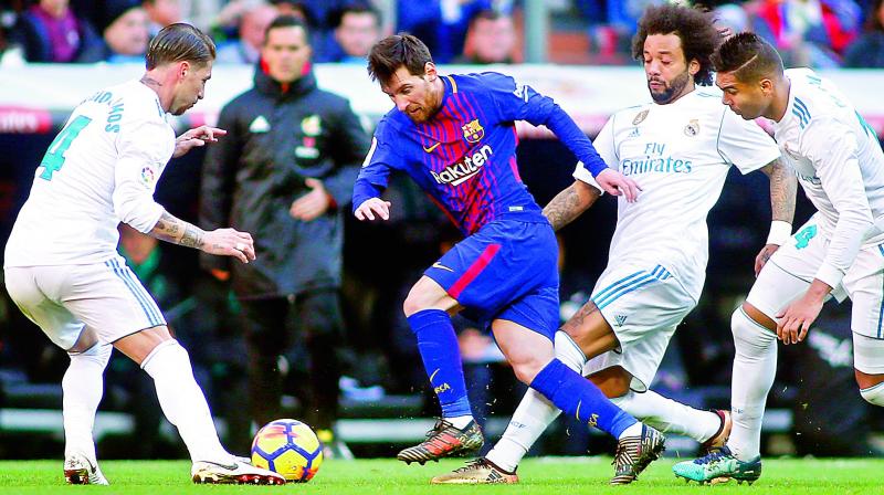 Barcelonas forward Lionel Messi (centre) vies with Real Madrids defenders Sergio Ramos (left), Marcelo and Casemiro (right) during their Spanish League â€œClasicoâ€ football match at the Santiago Bernabeu stadium in Madrid on Sunday. Barcelona won 3-0. (Photo: AFP)