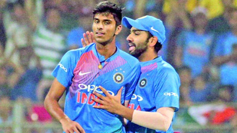 Indias Washington Sundar (left) celebrates the wicket of Sri Lankas Upul Tharanga along with captain Rohit Sharma during the 3rd T20 in Mumbai. (Photo: PTI)