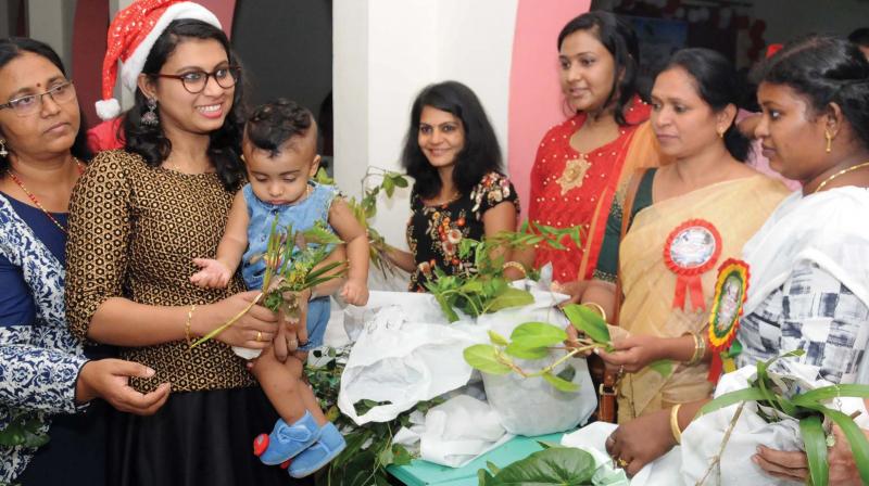 Members of the Facebook collective exchange plants during a gathering in Kochi. (Photo: DC)
