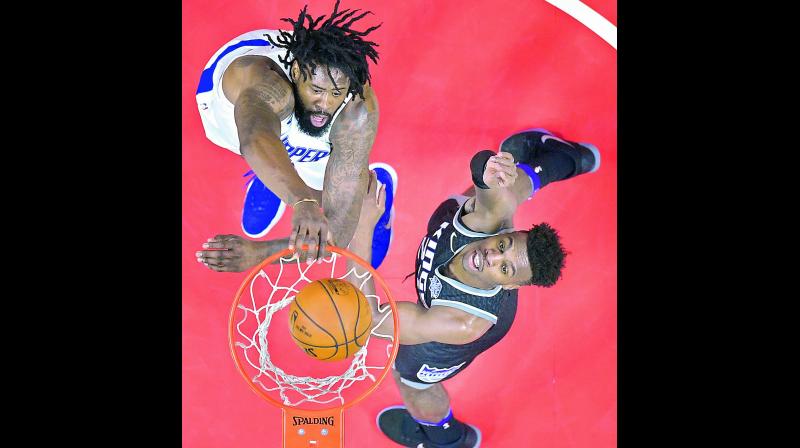 LA Clippers centre DeAndre Jordan dunks over Sacramento Kings forward Justin Jackson during their NBA basketball game in Los Angeles on Tuesday. The Clippers won 122-95. 	(Photo: AP)