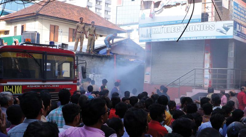 Fire and rescue force personnel douse the fire at Electronic street near Pallimukku in Kochi on Thursday. (Photo: DC)