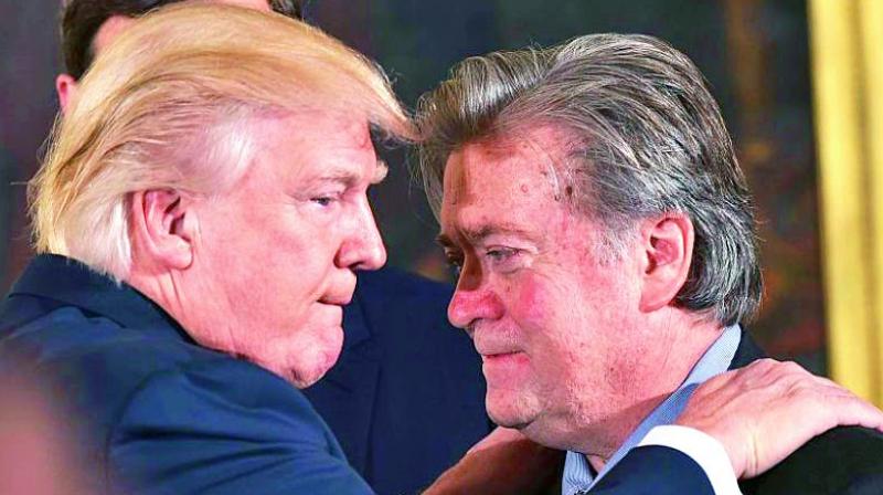 President Donald Trump embraces thenchief strategist Stephen Bannon at the January 22 swearing-in ceremony for senior White House staff.