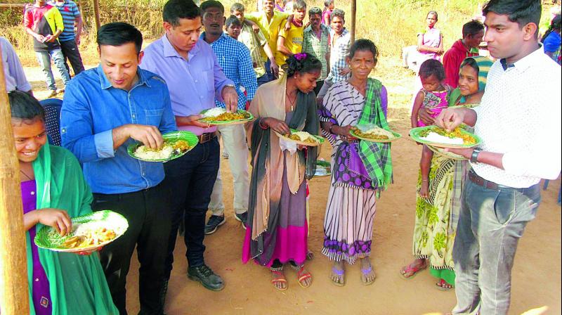 District collector Pravin Kumar and Vizag Rural Police chief Rahul Dev Sharma take part in community lunch with villagers at Pedapadu area during Sadbhavana Yatra on Wednesday.