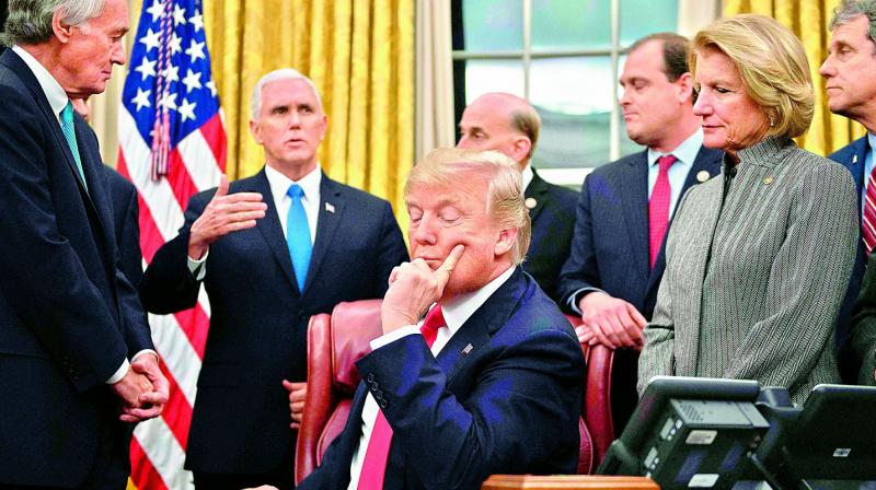 US President Donald Trump (C) with lawmakers at the White House in Washington, DC.
