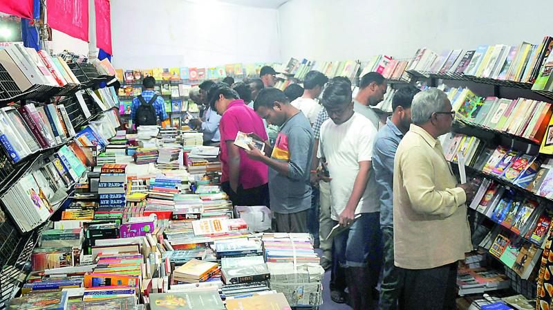 People purchasing books at the 31st Hyderabad National Book Fair at NTR stadium on Thursday. (Photo:DC)