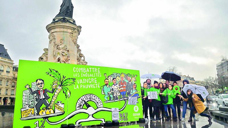 Militants of Oxfam France demonstrate on Monday on the Place de la Republique (Republic Square) in Paris for the launching of the campaign against inequality. (Photo:AFP)