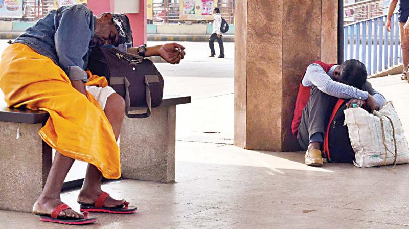 Commuters wait for BMTC services to resume at the Majestic station on Thursday.  (Photo:DC)