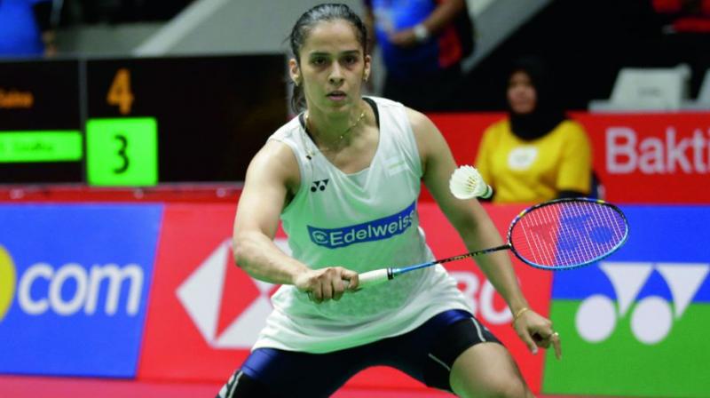 Saina Nehwal returns to P.V. Sindhu in their Indonesian Masters quarterfinal match at Jakarta on Friday. (Photo:AP)