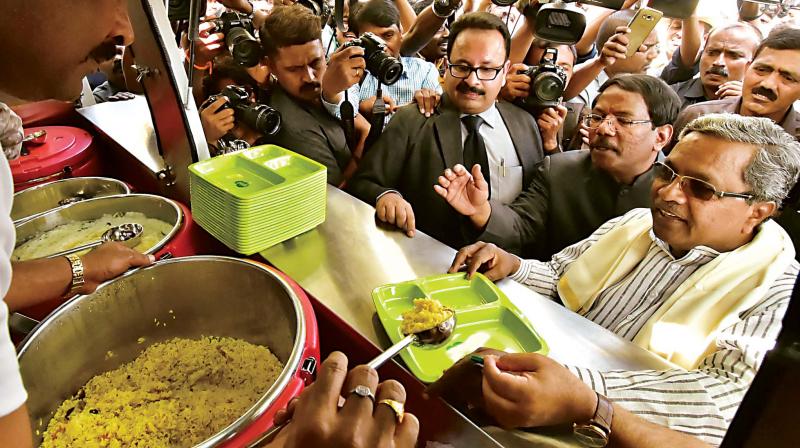 Chief Minister Siddaramaiah having food during the launch of a mobile Indira Canteen in Bengaluru on Friday. (Photo:KPN )