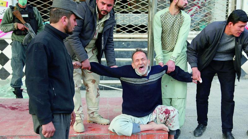 A relative of a victim is helped as he cries after a deadly suicide attack in Kabul on Saturday, when a bomb placed in an ambulance exploded killing at least 95 persons and wounding over 100. The attack has been claimed by the Taliban. (Photo: AP)
