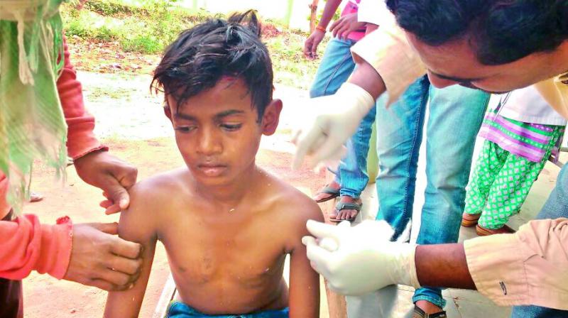 Doctors treat Venkat Krishna who was injured in the road mishap at Kothagudem on Sunday.