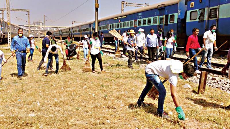 Volunteers from Eco-Watch clean the premises of City Central Railway Station in Bengaluru on Wednesday. (Photo:DC)