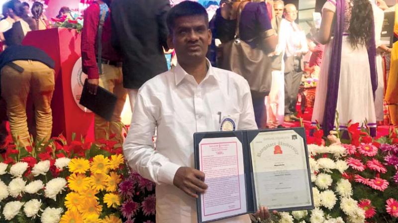 Nagashetty, who is visually impaired, with his PhD degree certificate. (Photo: DC)