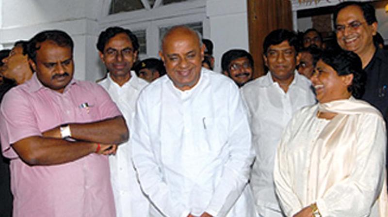 JD(S) supremo Deve Gowda, son H.D. Kumaraswamy  and BSP supremo Mayawati in a file photograph