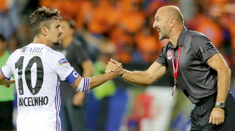 FC Pune Citys Marcelinho is congratulated by coach Ranko Popovic after their ISL-4 match in Mumbai.
