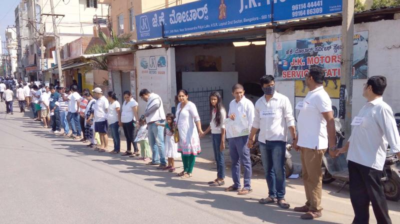 Residents of HSR Layout form a human chain to protest against the compost plant in the area on Sunday.  (Photo:DC)