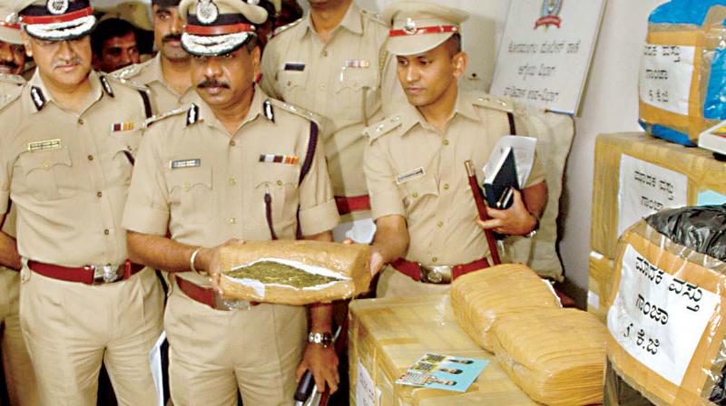 City Police Commissioner T. Suneel Kumar with the seized 130 kg of ganja and the concealed fish containers at Police Commissioners office in Bengaluru on Wednesday. (Photo:DC)