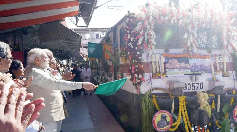 PM Narendra Modi flagged off the Palace Queen Humsafar Express between Mysuru and Udaipur, at Mysuru Railway Station on Monday. (Photo:KPN)