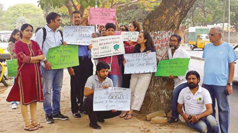 Environmental activists stage a protest against tree-cutting in Bengaluru.  (Photo:DC)