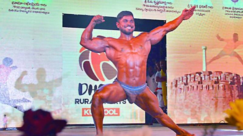 Sudhir flexes his muscles at a body building competition.