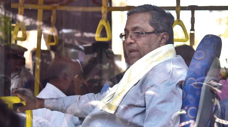 Chief Minister Siddaramaiah arrives to inaugurate the remodelled Church Street in a BMTC Volvo bus on Thursday. (Photo:DC)